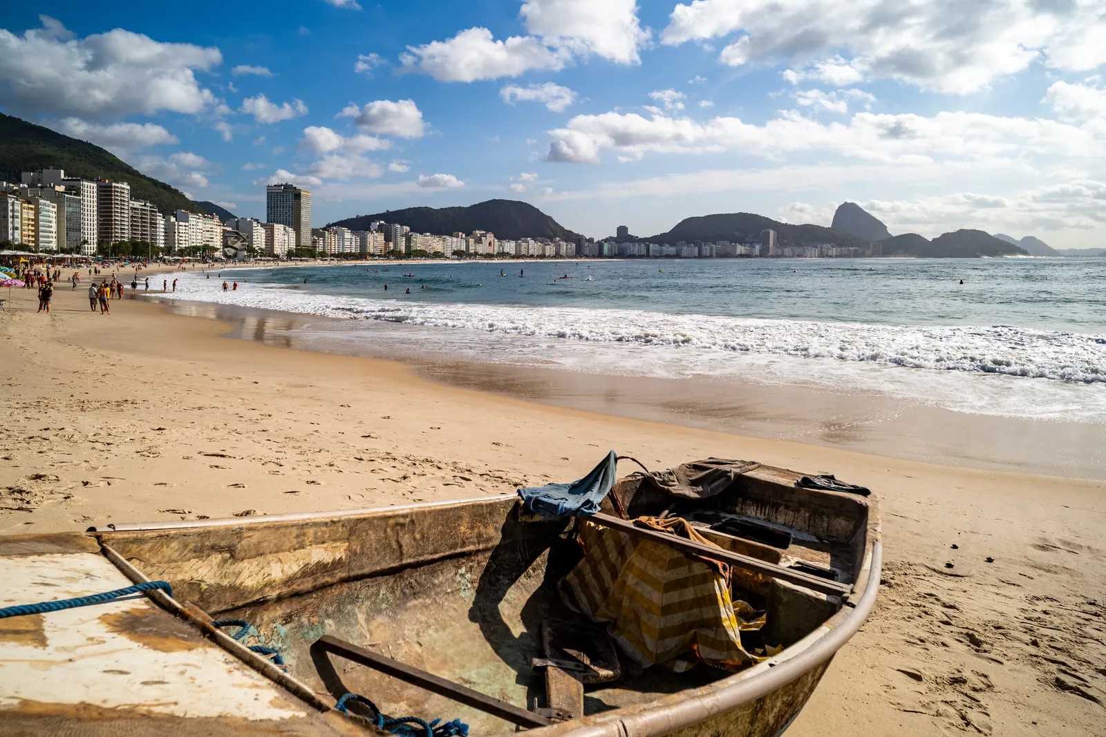 A fishing boat on the sand, Sugarloaf in the distance
