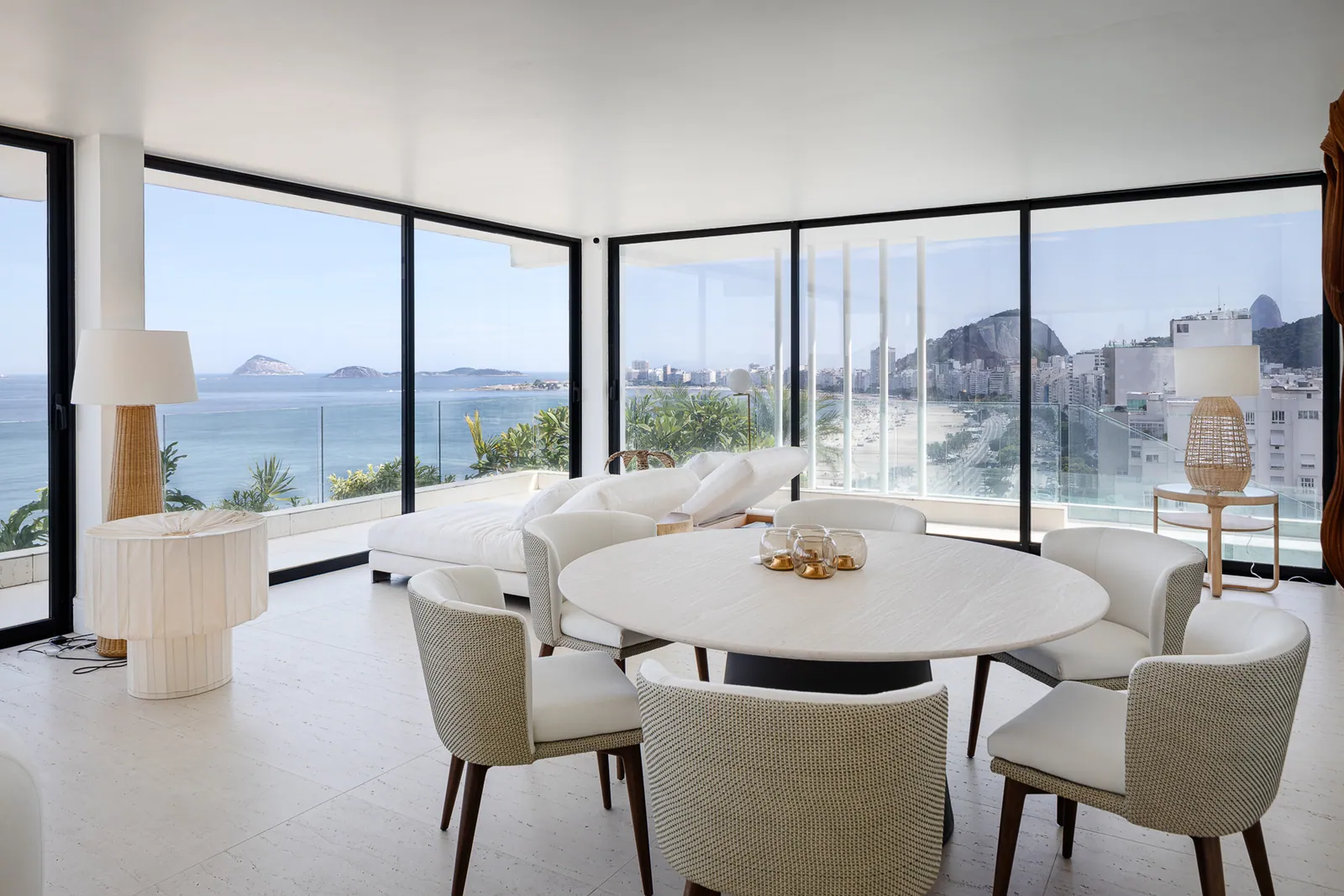 Round dining table and cane chairs against the glass