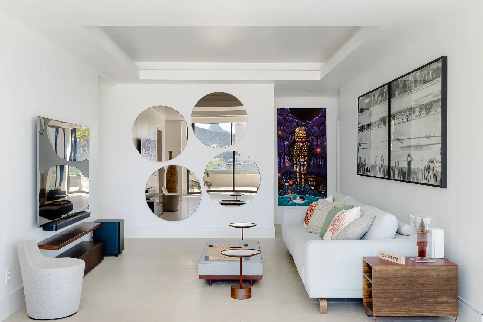Seating area with television and circular mirror composition