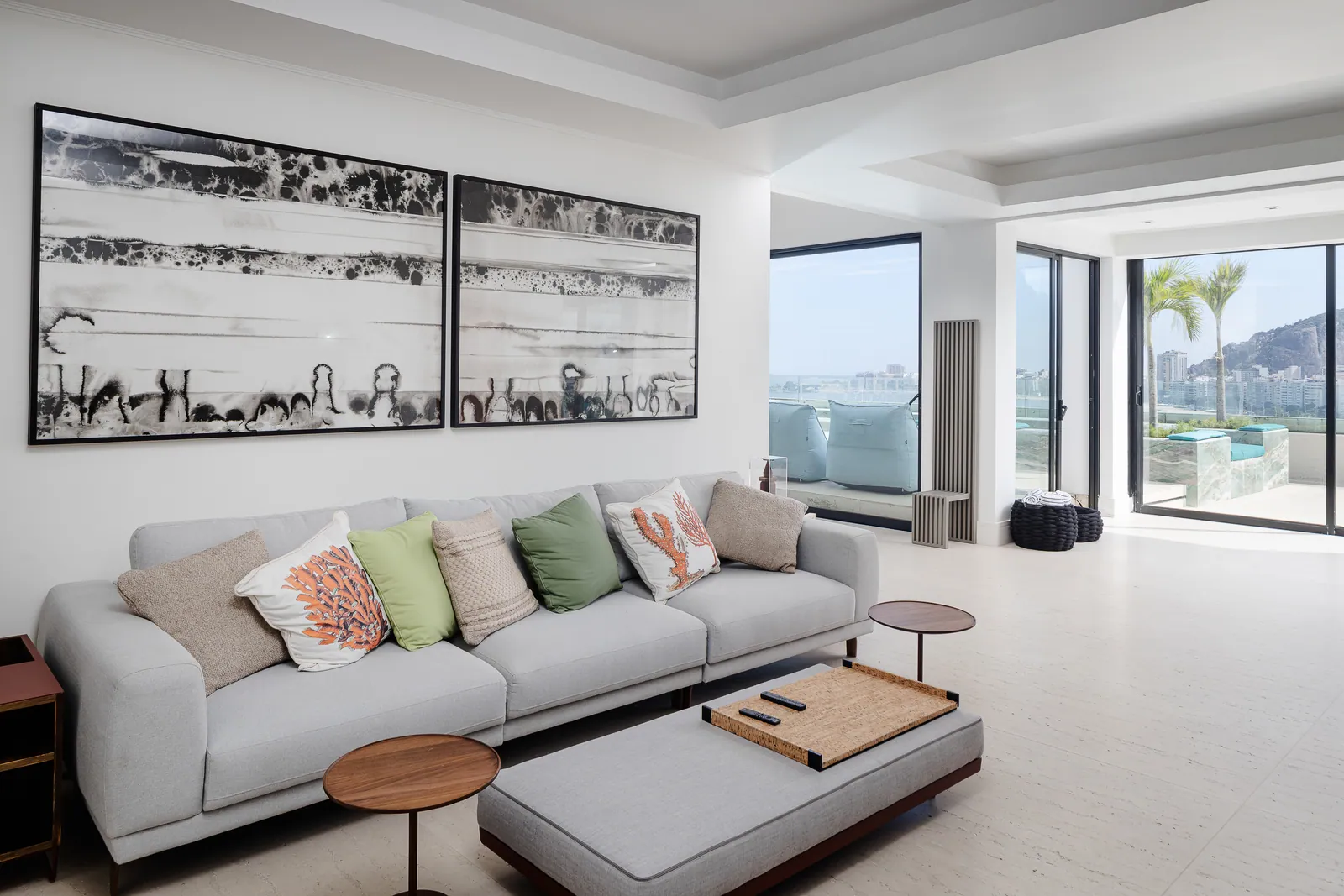 Living room with black-and-white photographs, terrace beyond