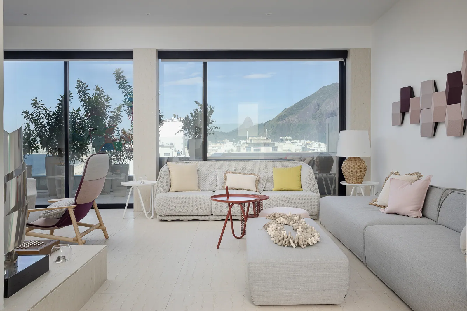 Grey sofas in the family living room, hills through the window