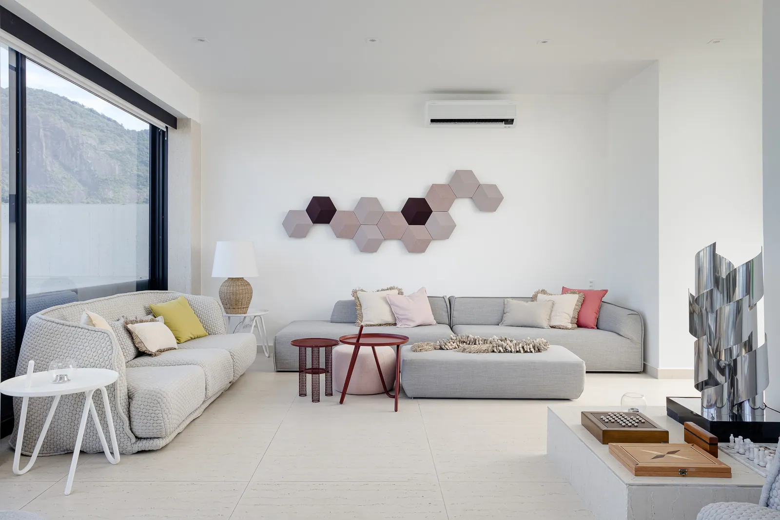 Family room with hexagonal wall panels and low seating