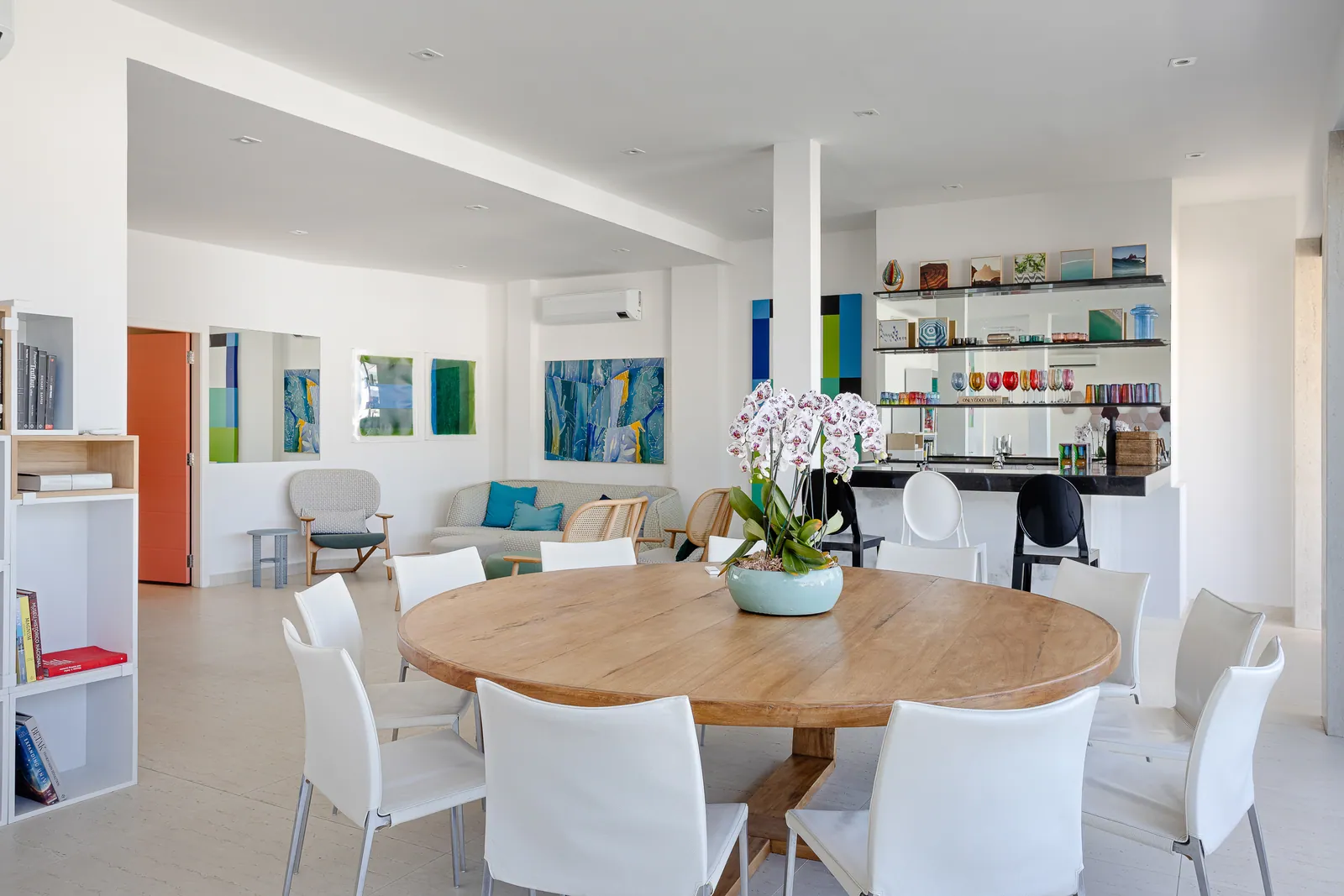 Round dining table and bookshelves in the informal dining room
