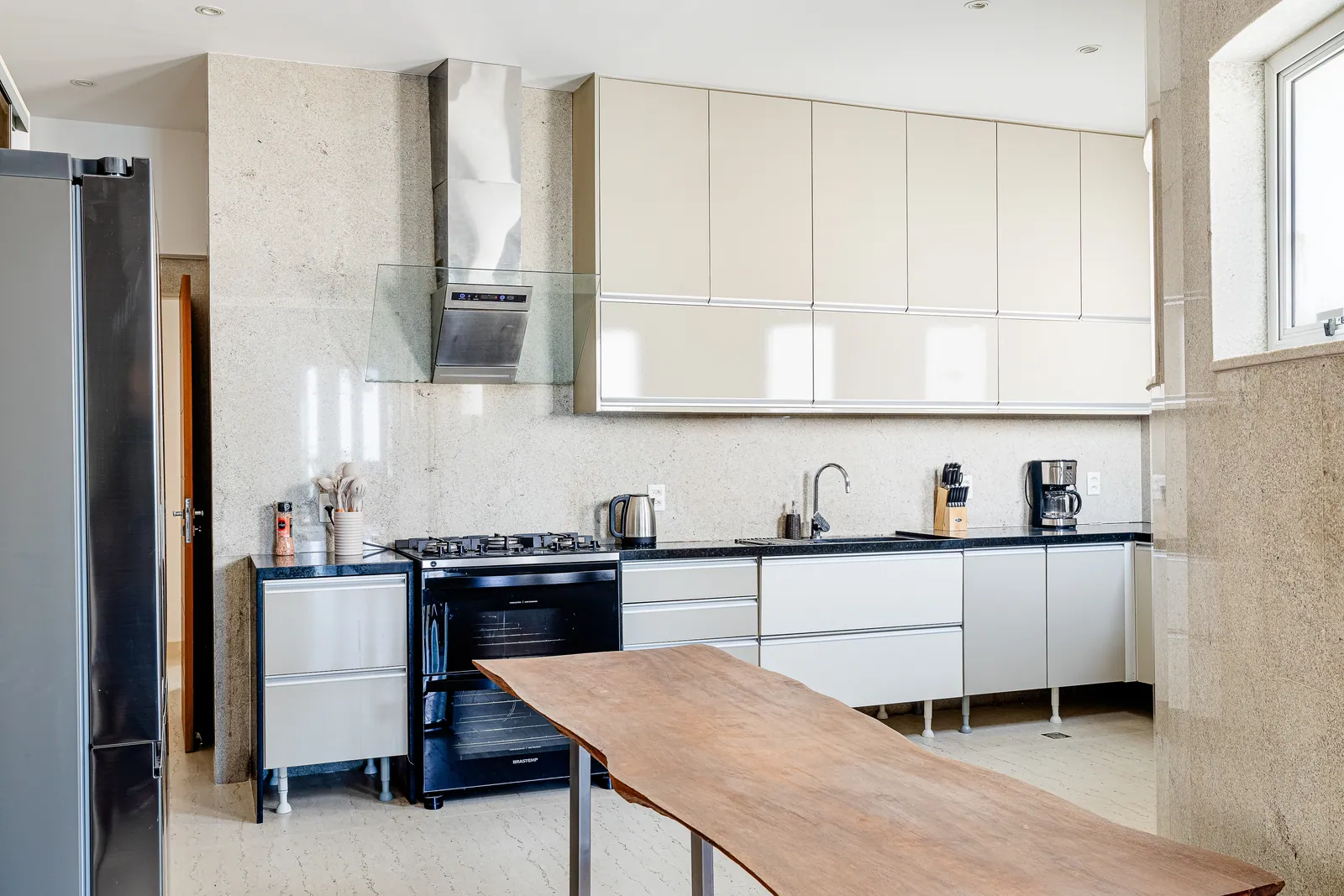 Kitchen with wood counter, range and full-height cabinets