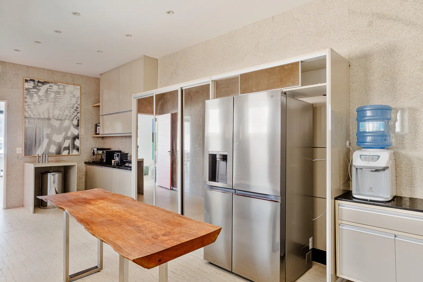 Second kitchen with large refrigerator and solid wood table