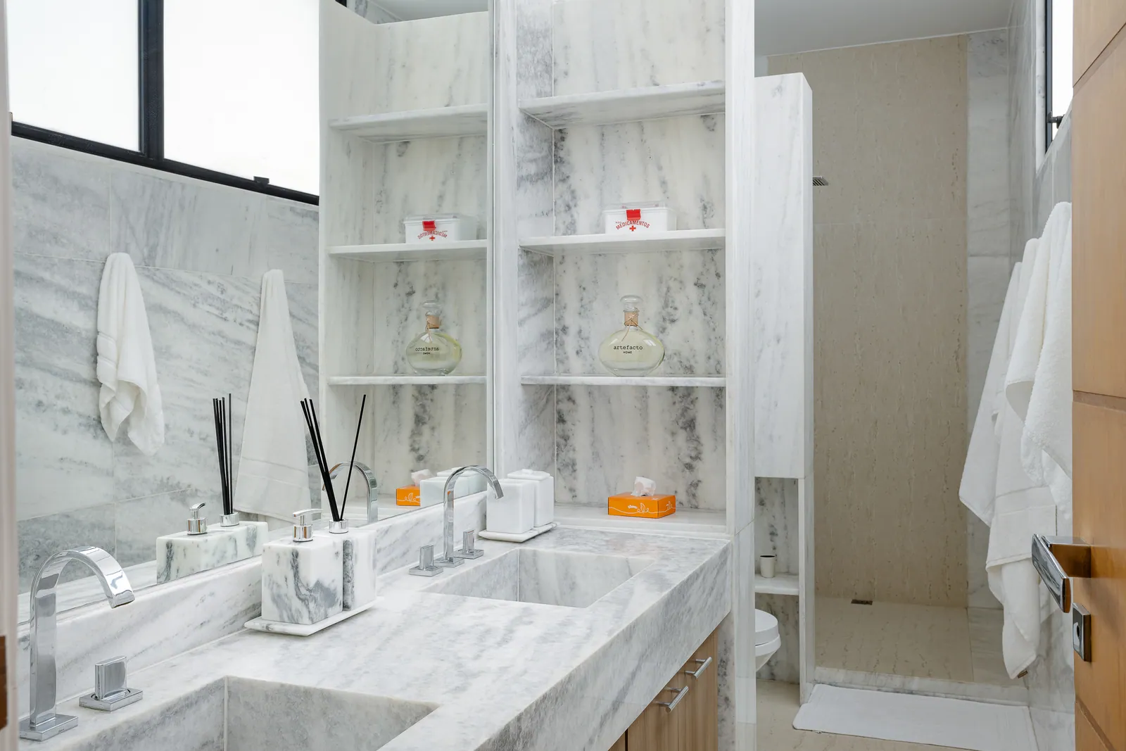 Marble bathroom with double vanity and walk-in shower