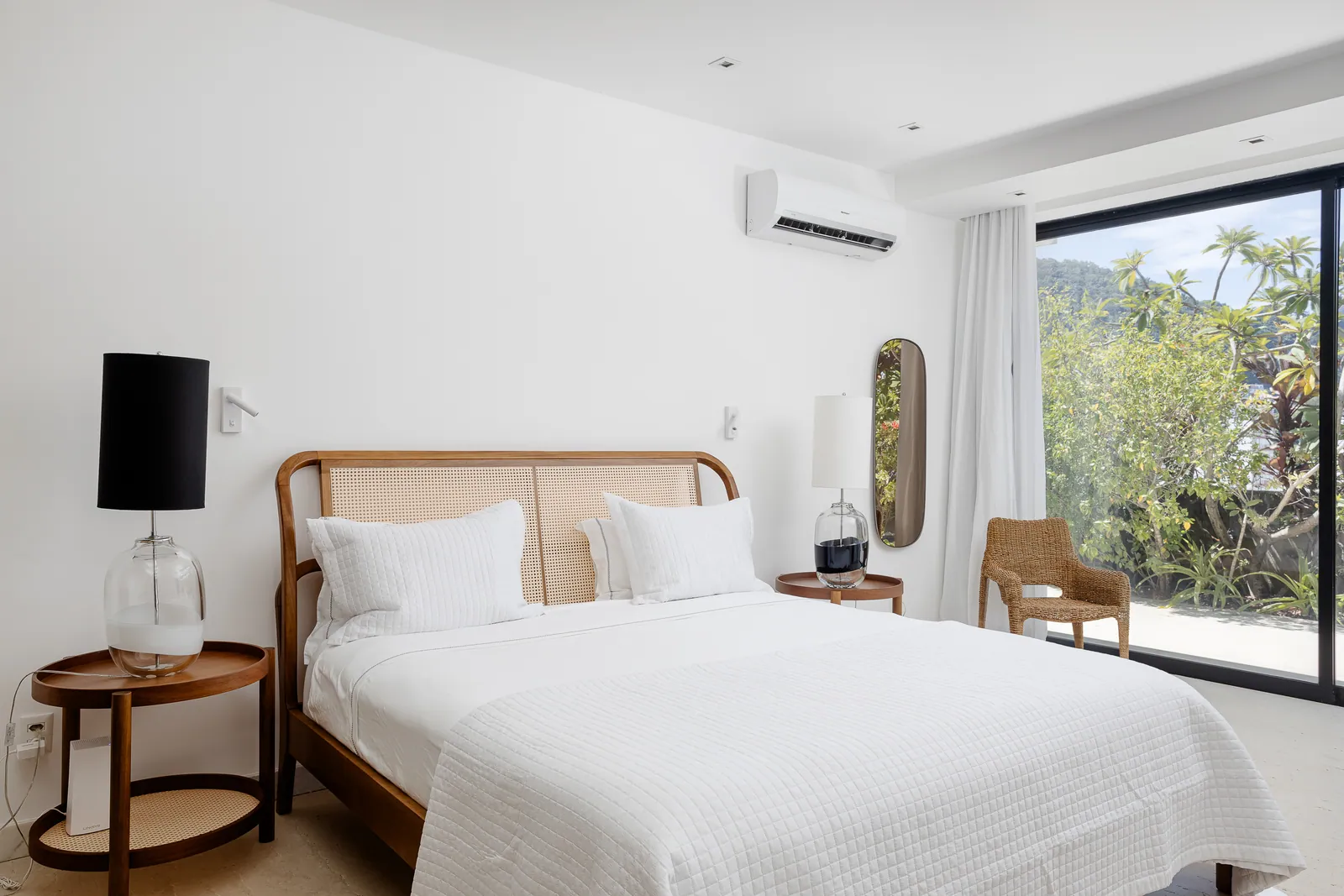 Bedroom with wood headboard and garden outlook