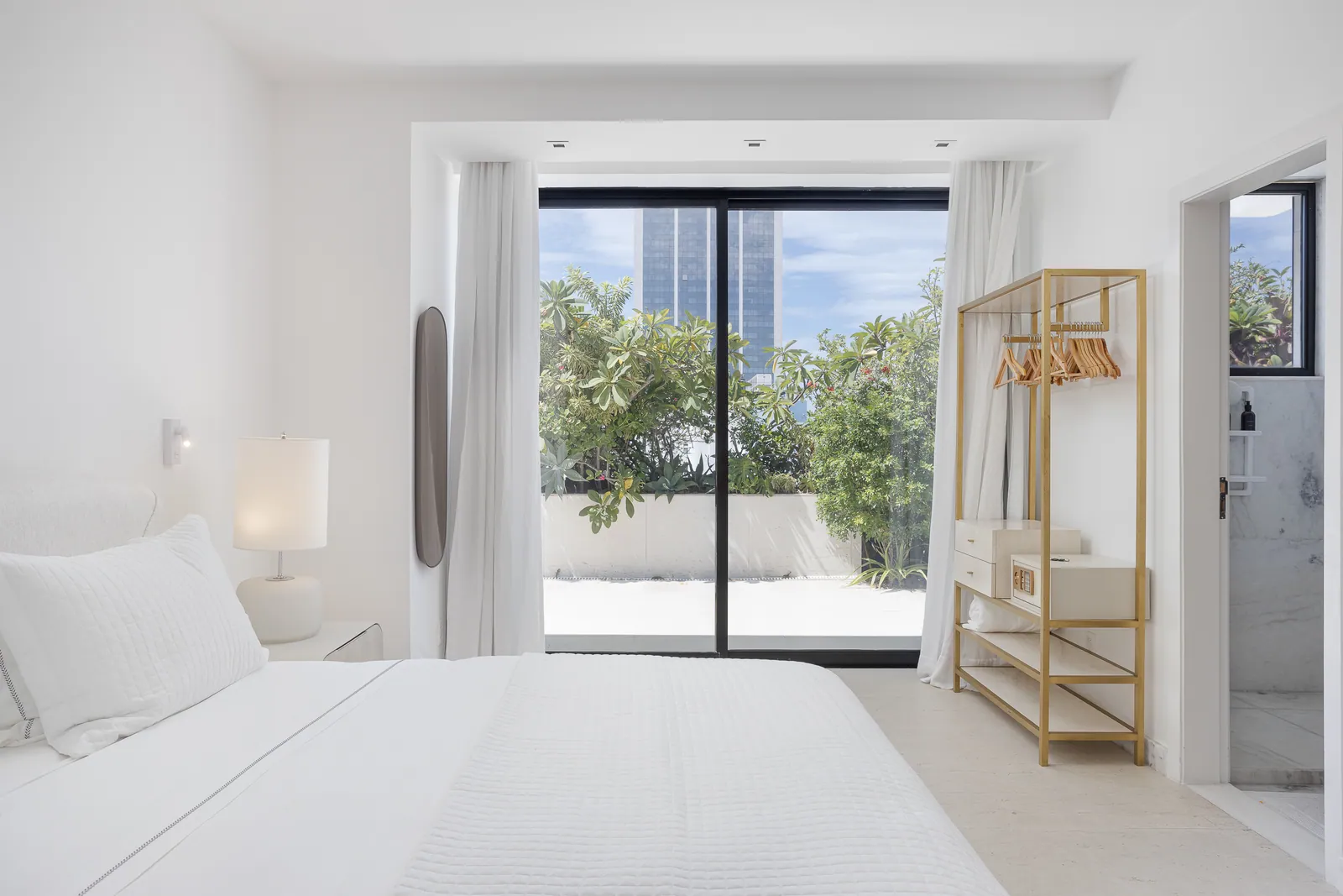 Bedroom opening onto the terrace, open clothes rack