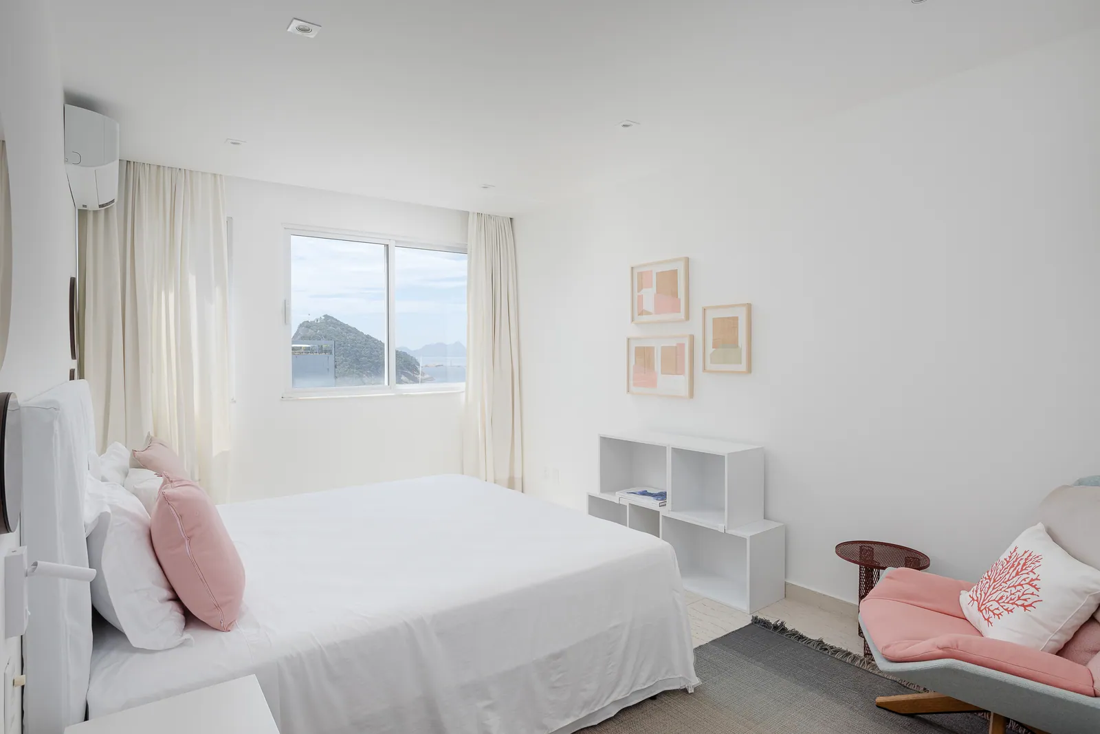 Bedroom with soft pink cushions and window seat