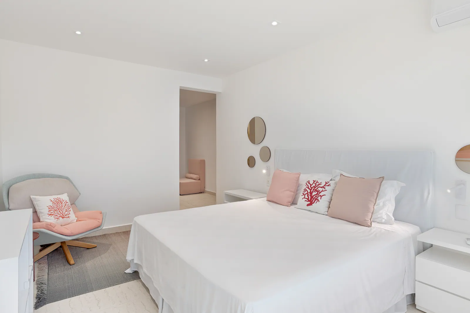 Bedroom in coral tones with swivel armchair