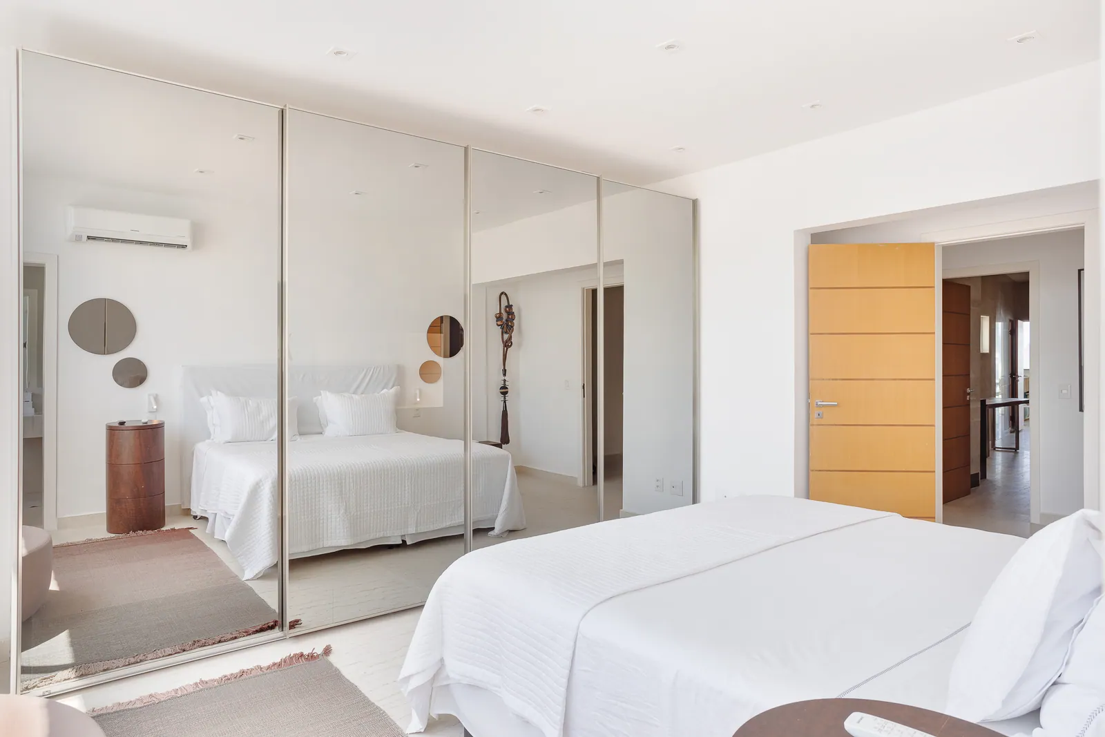Bedroom with mirrored wardrobe running the full wall