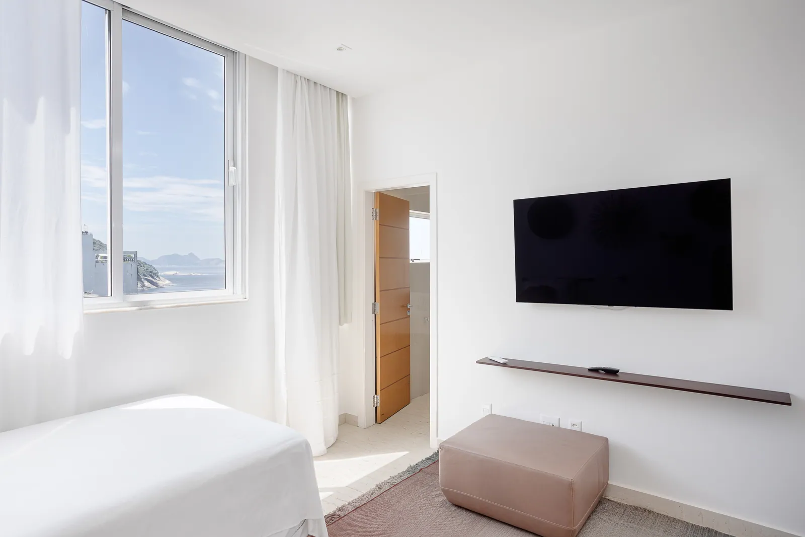 Bedroom with television and sea-facing window