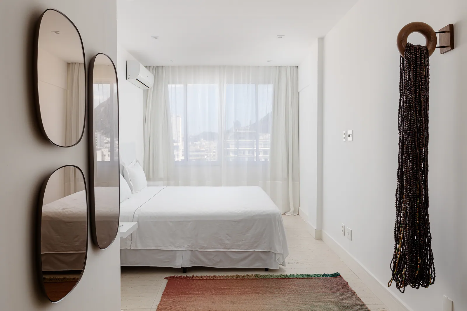 Bedroom with oval mirrors and patterned rug