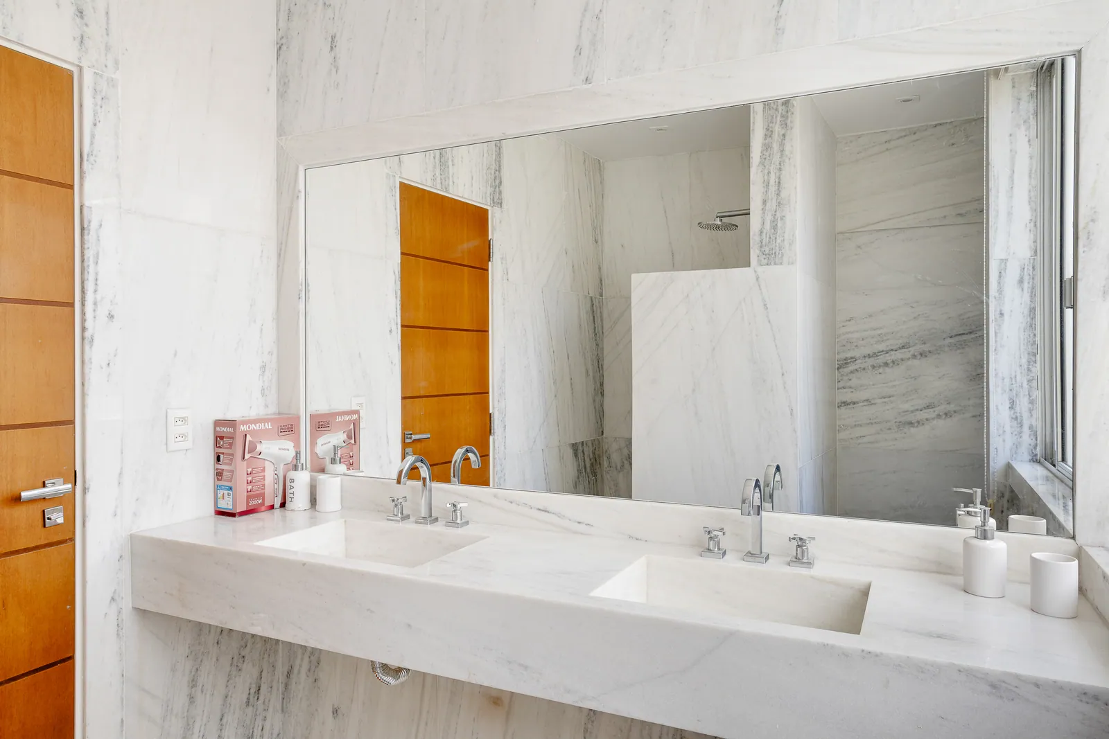 Marble bathroom with double vanity and full-width mirror
