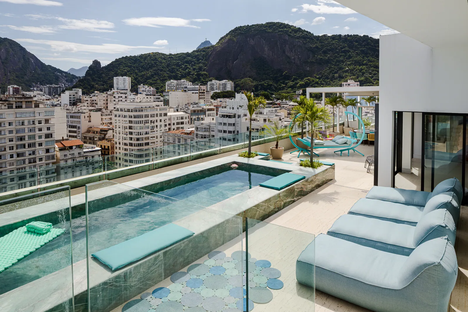 Sun loungers beside the pool, city and hills in the distance