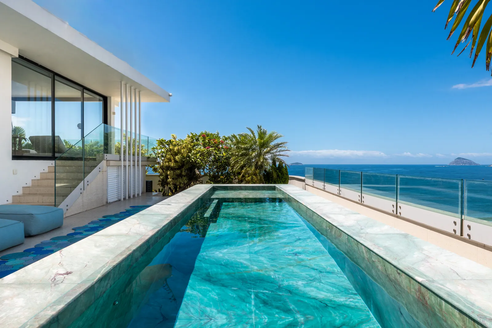 The pool set against the glass wall of the living room