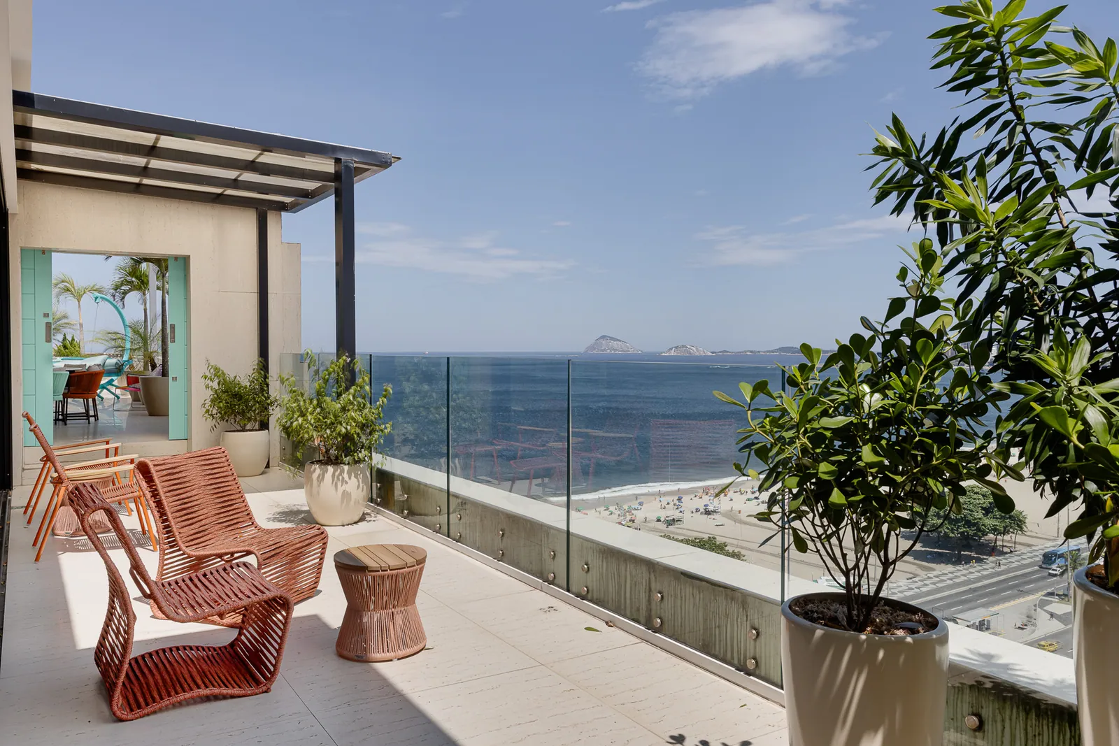 Rattan armchairs on the terrace facing the open Atlantic