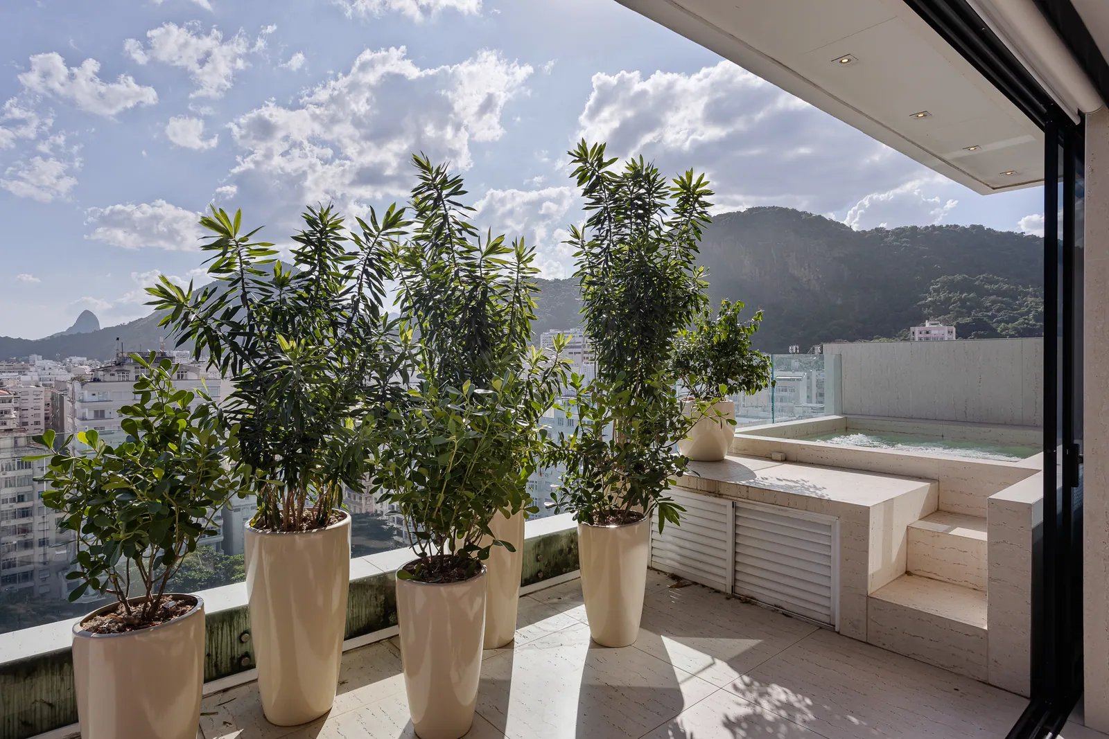 Jacuzzi set within the planted second terrace, hills behind